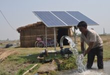 Indian villager using solar panels for water extraction, exemplifying the realization of the Sustainable Development Goals SDGs by 2030 to empower local governments and communities.