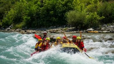 Competitors riding on kayak on a angry river, symbolizing the collective effort and urgency in achieving the UN 2030 SDG Goals through a science-driven framework of the SDGs.