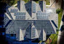 Renewable energy and energy efficiency in action with solar panels on a large house roof.